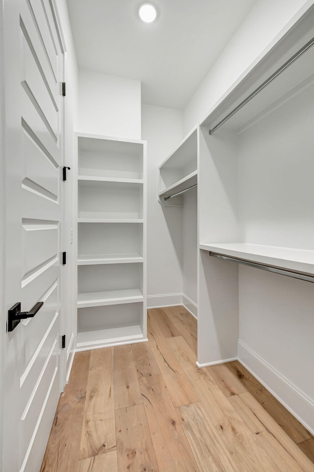 walk in closet featuring light hardwood / wood-style flooring