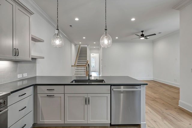 kitchen featuring pendant lighting, sink, dishwasher, gray cabinetry, and ornamental molding