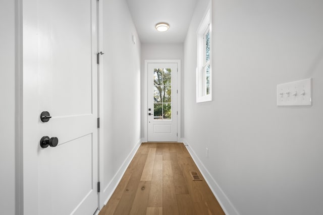 doorway with hardwood / wood-style flooring