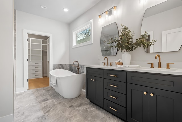 bathroom featuring vanity and a tub to relax in