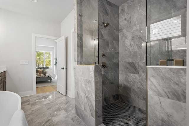 bathroom with vanity and tiled shower