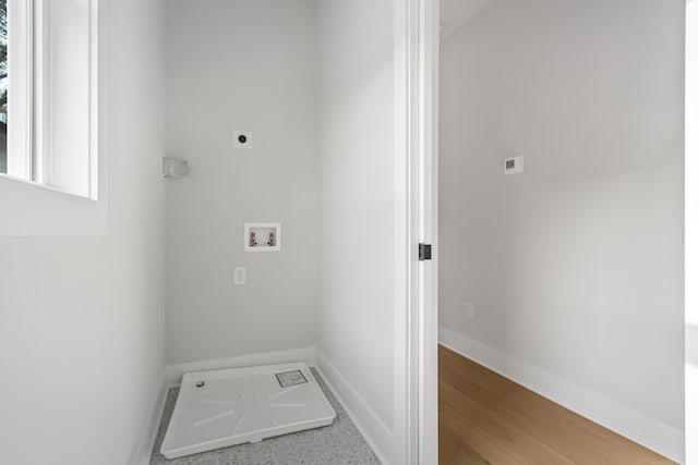 clothes washing area featuring hookup for a washing machine, electric dryer hookup, and wood-type flooring