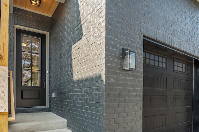 doorway to property with a garage