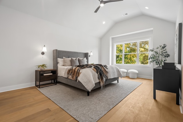 bedroom with hardwood / wood-style flooring, vaulted ceiling, and ceiling fan