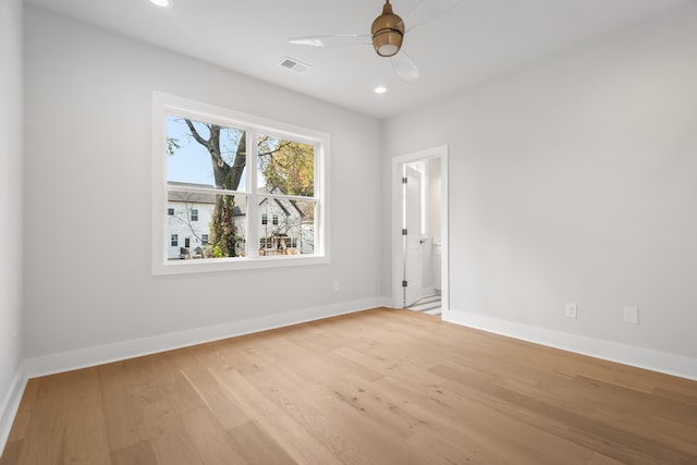 spare room with light hardwood / wood-style floors and ceiling fan