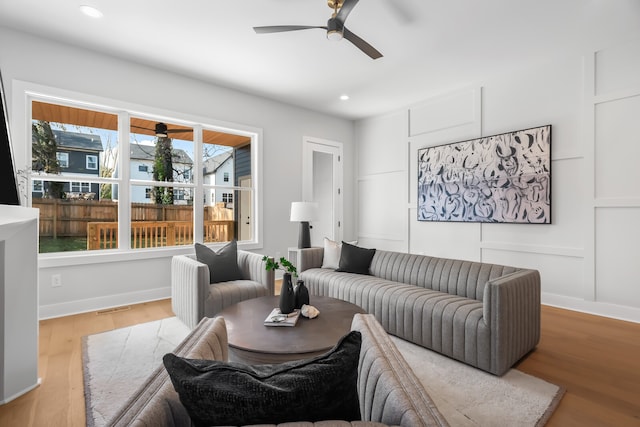 living room featuring hardwood / wood-style flooring and ceiling fan