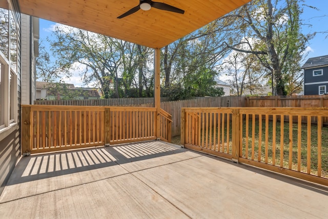 wooden terrace featuring a lawn and ceiling fan