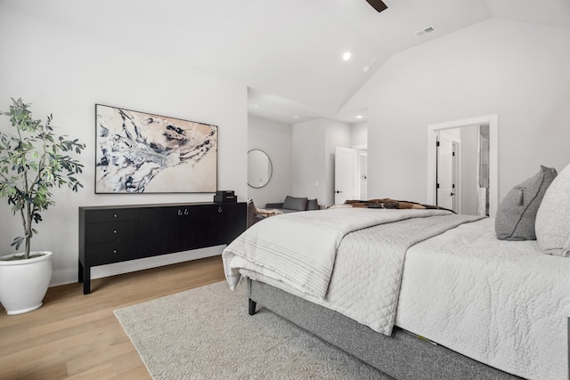 bedroom featuring connected bathroom, vaulted ceiling, hardwood / wood-style flooring, and ceiling fan