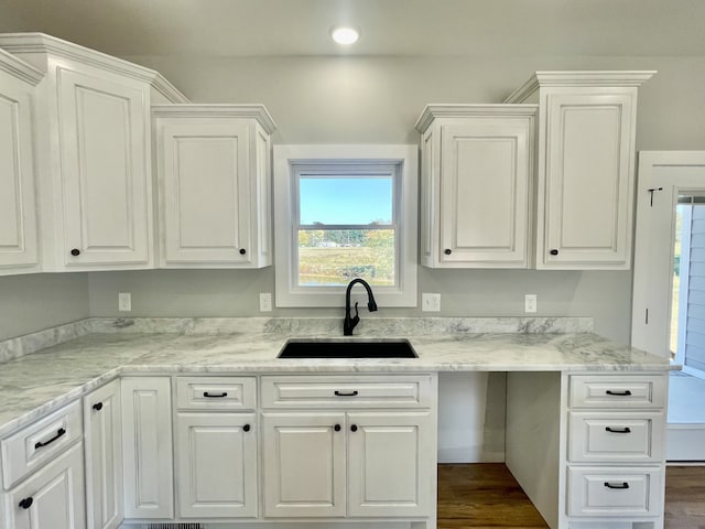 kitchen featuring sink, white cabinets, and plenty of natural light