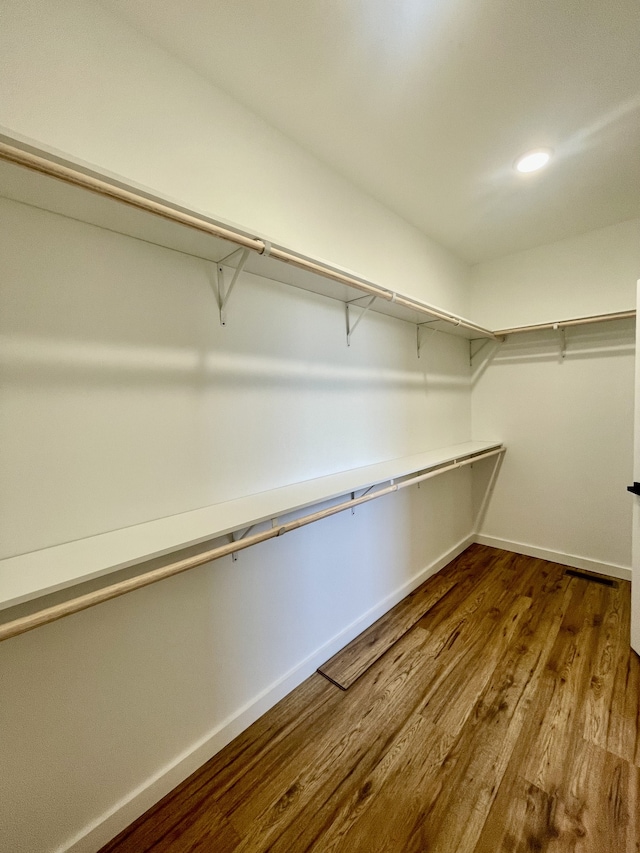 spacious closet featuring hardwood / wood-style flooring