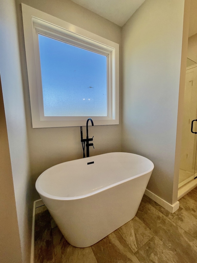 bathroom with separate shower and tub