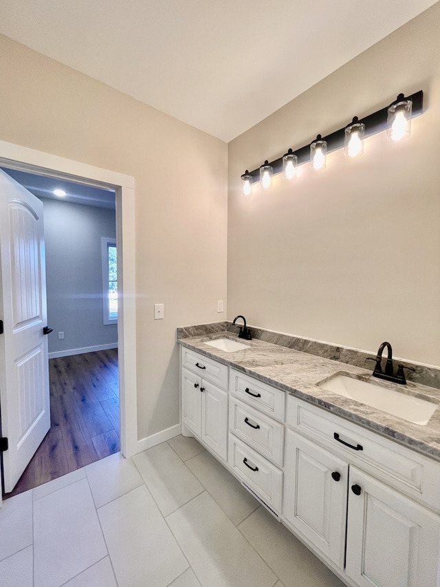 bathroom with vanity and wood-type flooring