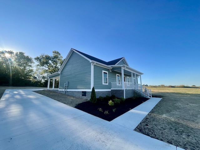 view of property exterior featuring covered porch