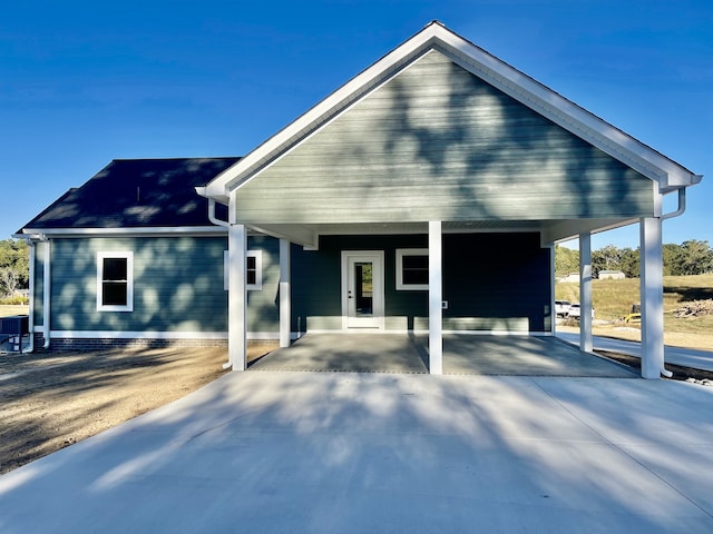 view of front facade with central air condition unit and a carport