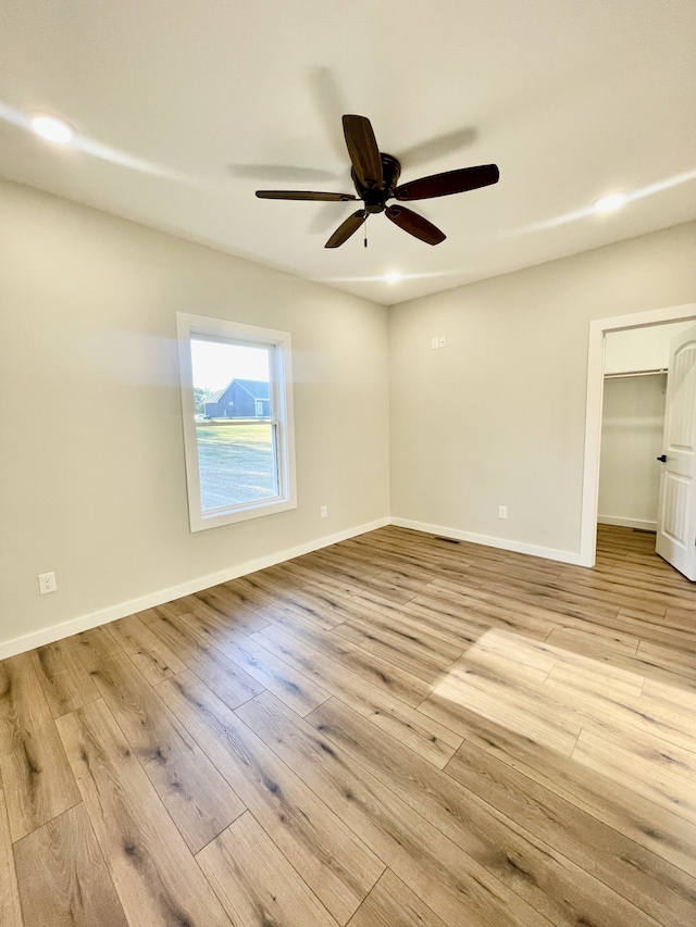 spare room with light hardwood / wood-style flooring and ceiling fan