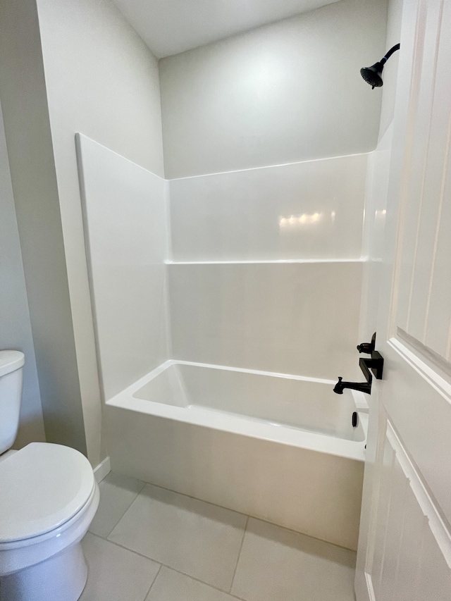 bathroom featuring toilet, shower / bathing tub combination, and tile patterned floors