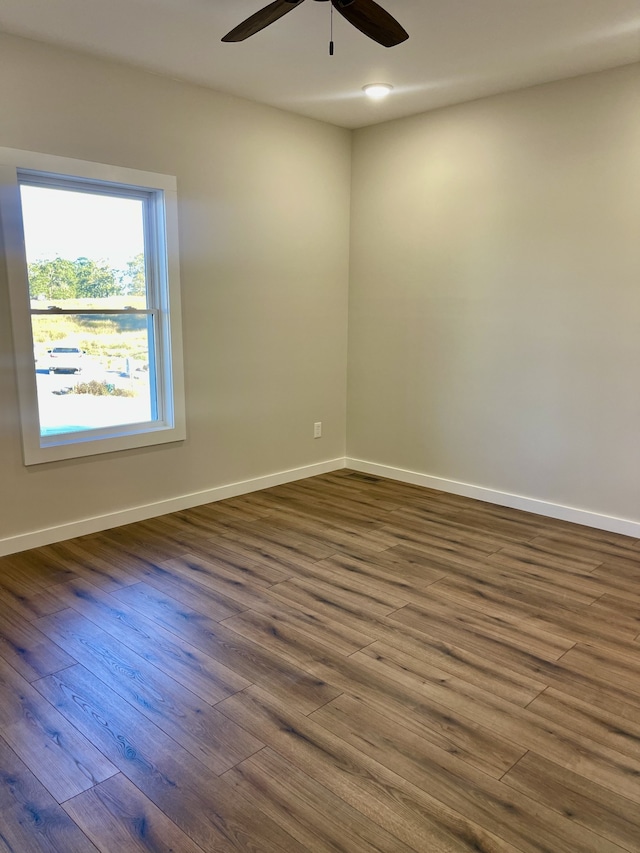 unfurnished room featuring ceiling fan and dark hardwood / wood-style floors