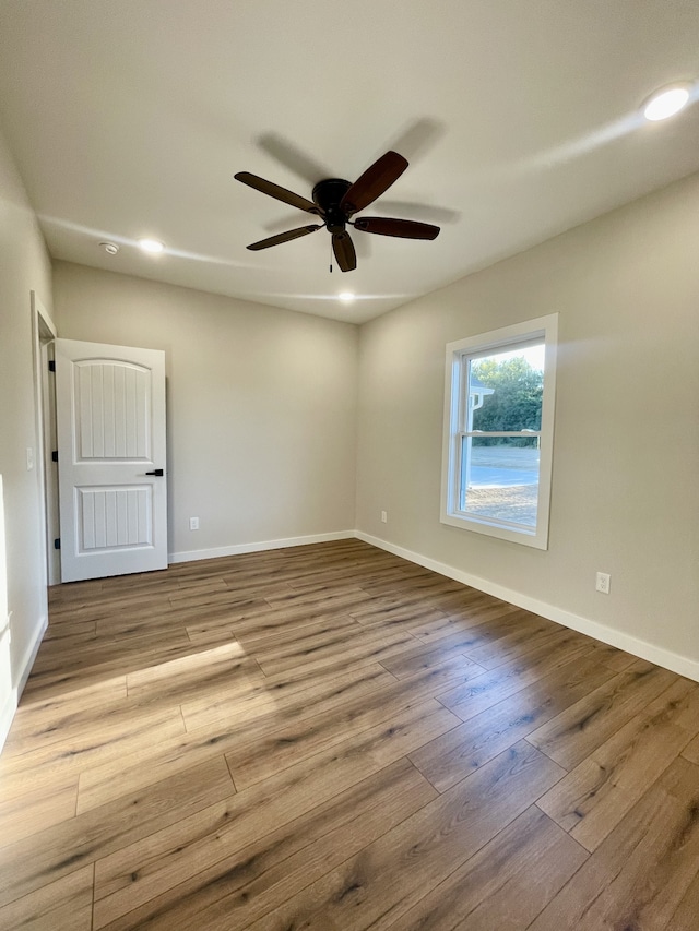 unfurnished room with light hardwood / wood-style flooring and ceiling fan