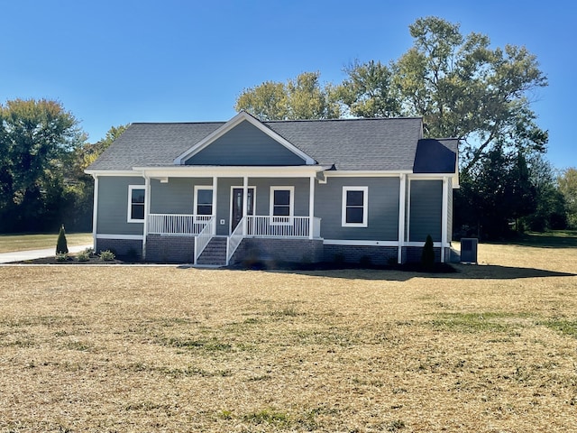 view of front of property with a front lawn, central air condition unit, and a porch