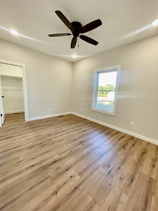 unfurnished room featuring ceiling fan and light hardwood / wood-style flooring