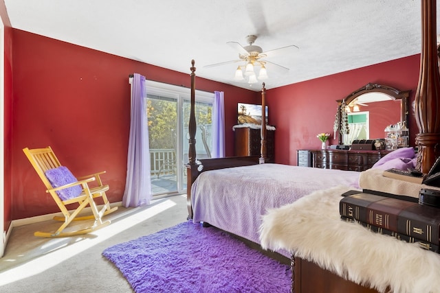 carpeted bedroom featuring access to exterior, a textured ceiling, and ceiling fan