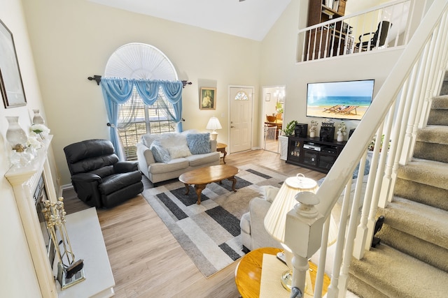 living room featuring high vaulted ceiling and light wood-type flooring