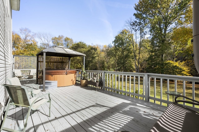 wooden deck featuring a gazebo and a hot tub