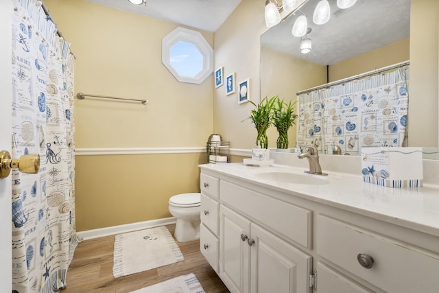 bathroom featuring hardwood / wood-style floors, vanity, and toilet