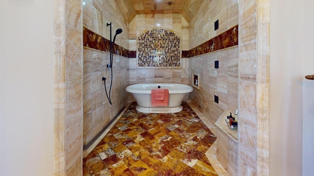 bathroom featuring tile walls and shower with separate bathtub