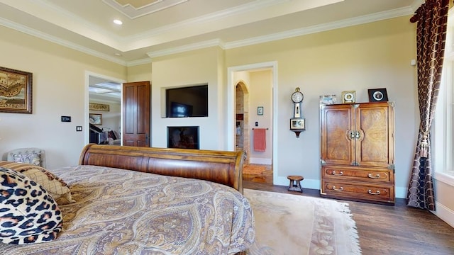 bedroom with crown molding and dark hardwood / wood-style floors