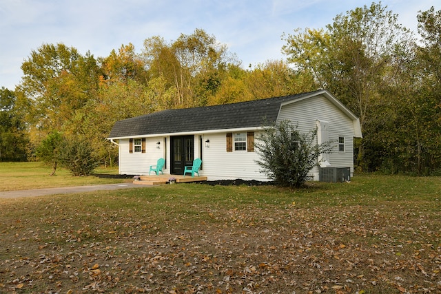 view of front of property with a front lawn and central AC unit