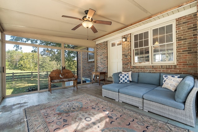 unfurnished sunroom with ceiling fan