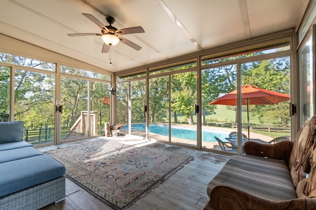 sunroom with ceiling fan and lofted ceiling