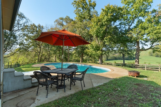 view of pool featuring a patio area and a yard