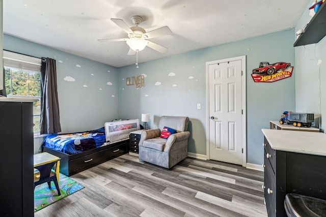 bedroom with ceiling fan and wood-type flooring