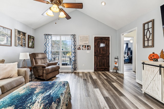 living room with a barn door, high vaulted ceiling, wood-type flooring, and ceiling fan