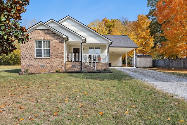 view of front of house with covered porch, a storage unit, and a front lawn