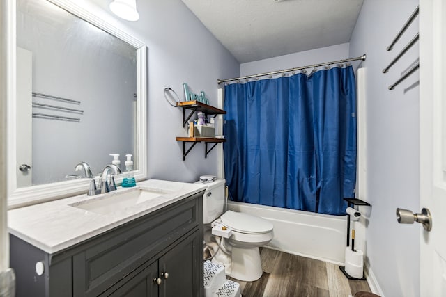 full bathroom featuring toilet, wood-type flooring, vanity, a textured ceiling, and shower / bathtub combination with curtain