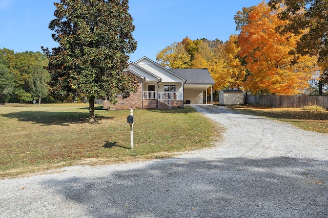 view of front of home with a storage unit, a front lawn, and a porch