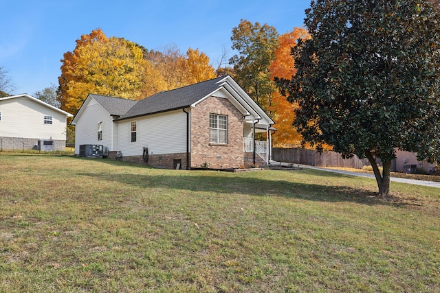 view of side of home featuring central air condition unit and a lawn