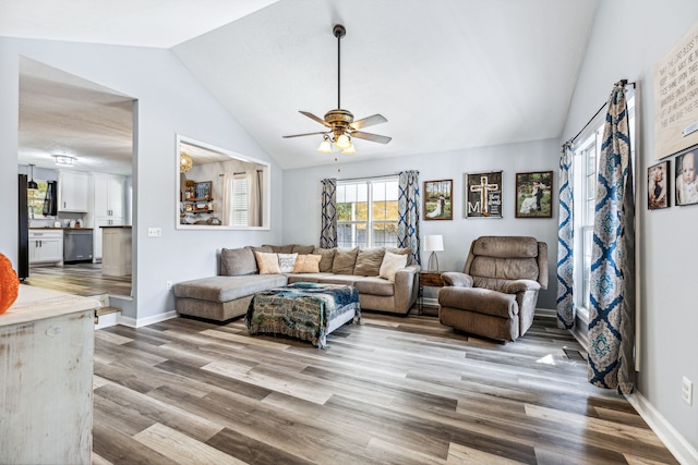 living room with lofted ceiling, light wood-type flooring, and ceiling fan