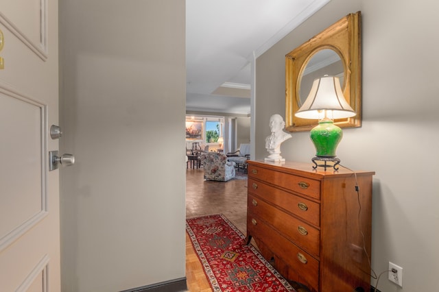 corridor featuring dark wood-type flooring and ornamental molding