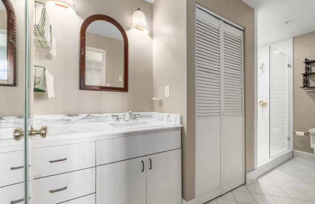 bathroom with vanity, a shower with shower door, and tile patterned flooring