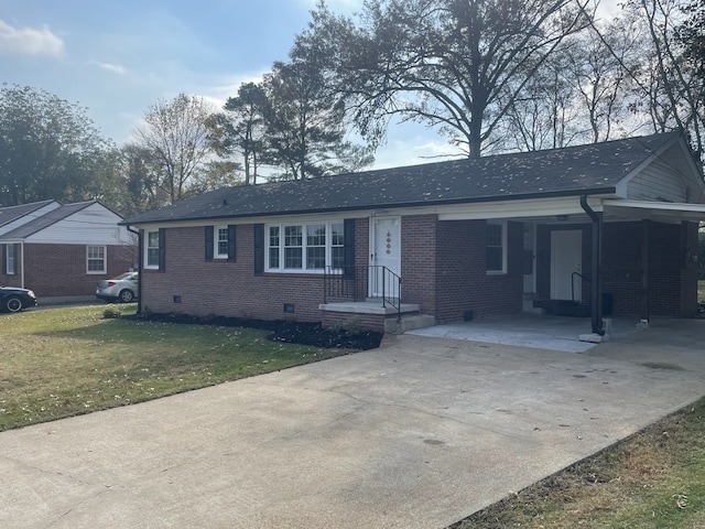 ranch-style house with a carport and a front lawn