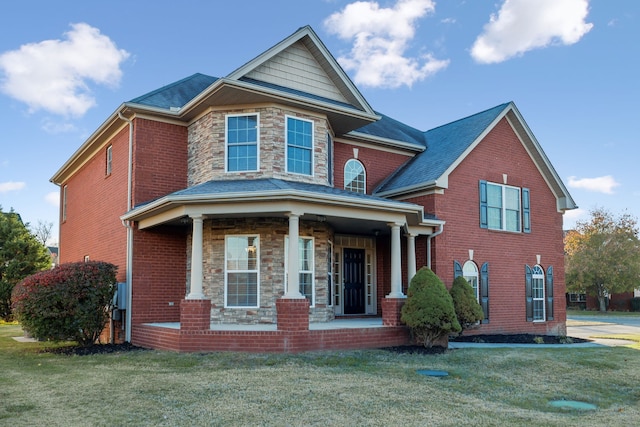 view of front of house with a porch and a front yard