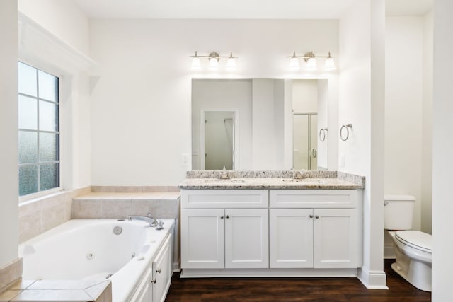 full bathroom with hardwood / wood-style floors, vanity, toilet, and independent shower and bath