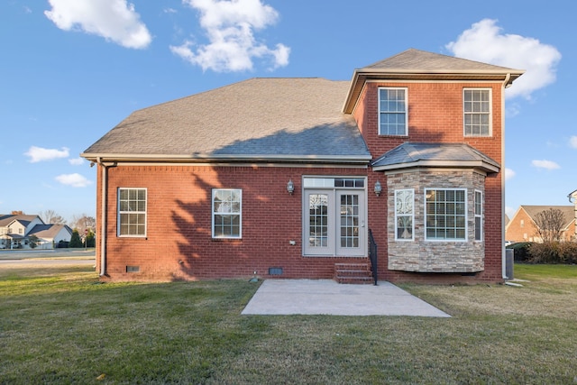 back of property with a patio area and a lawn