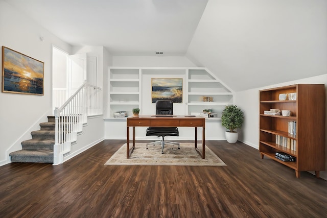 office space featuring built in shelves, dark hardwood / wood-style flooring, and lofted ceiling