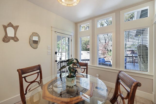 tiled dining room with a healthy amount of sunlight