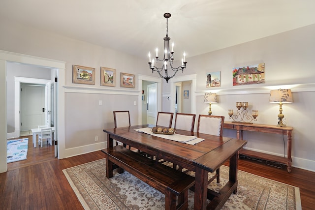 dining area featuring a notable chandelier and dark hardwood / wood-style flooring